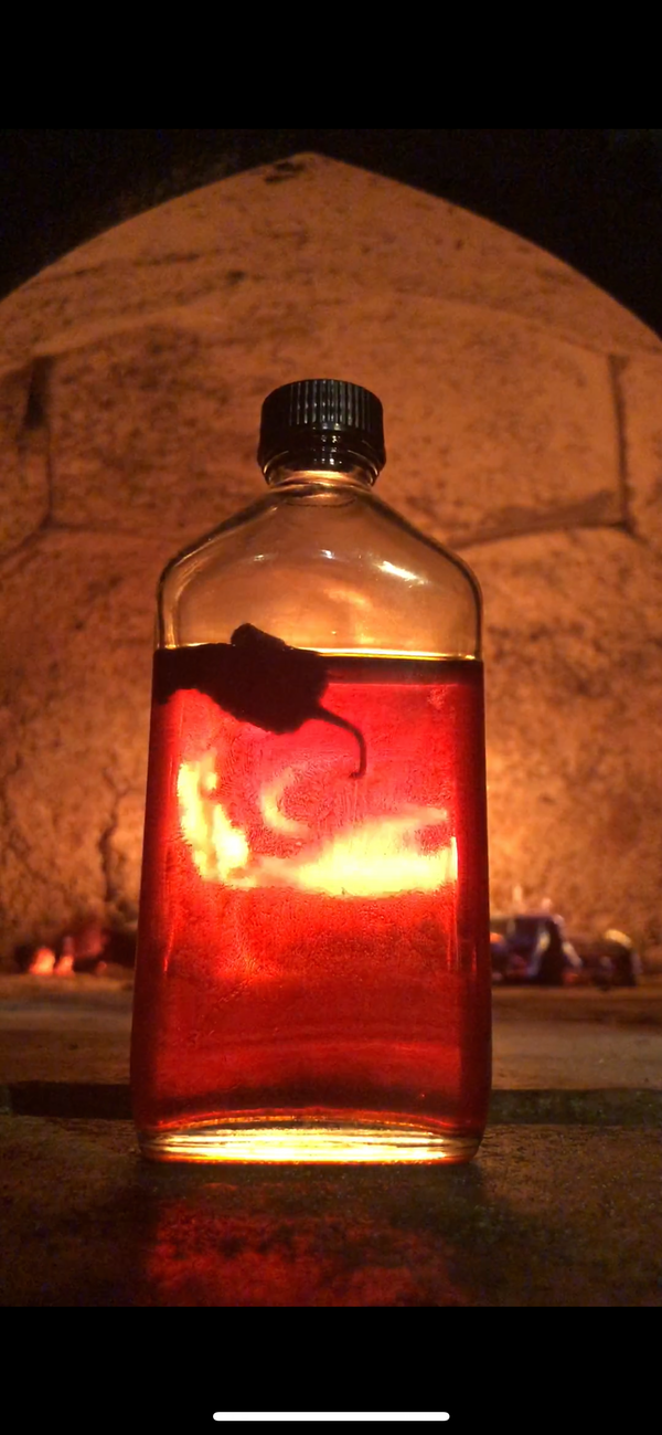 Old Bones Chilli Co Spiced Chilli Oil Bottle in front of fireplace